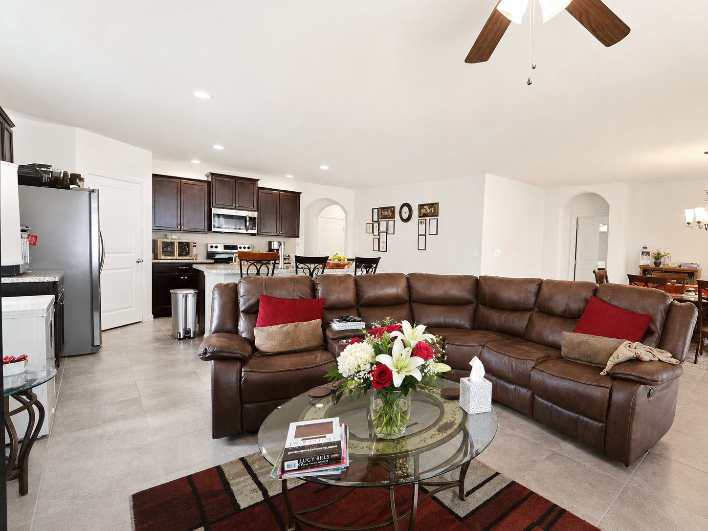 Open-concept living room at Albert's Manor with leather seating and view into the kitchen