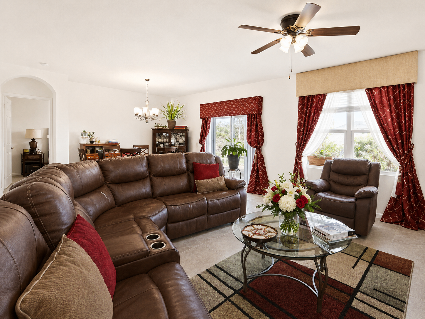 Living room at Albert's Manor with plush seating, natural light, and elegant window treatments